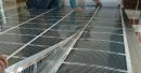 Installation d'un plancher chauffant infrarouge sous le stratifié