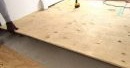Pose de contreplaqué sur un sol en béton sous un stratifié